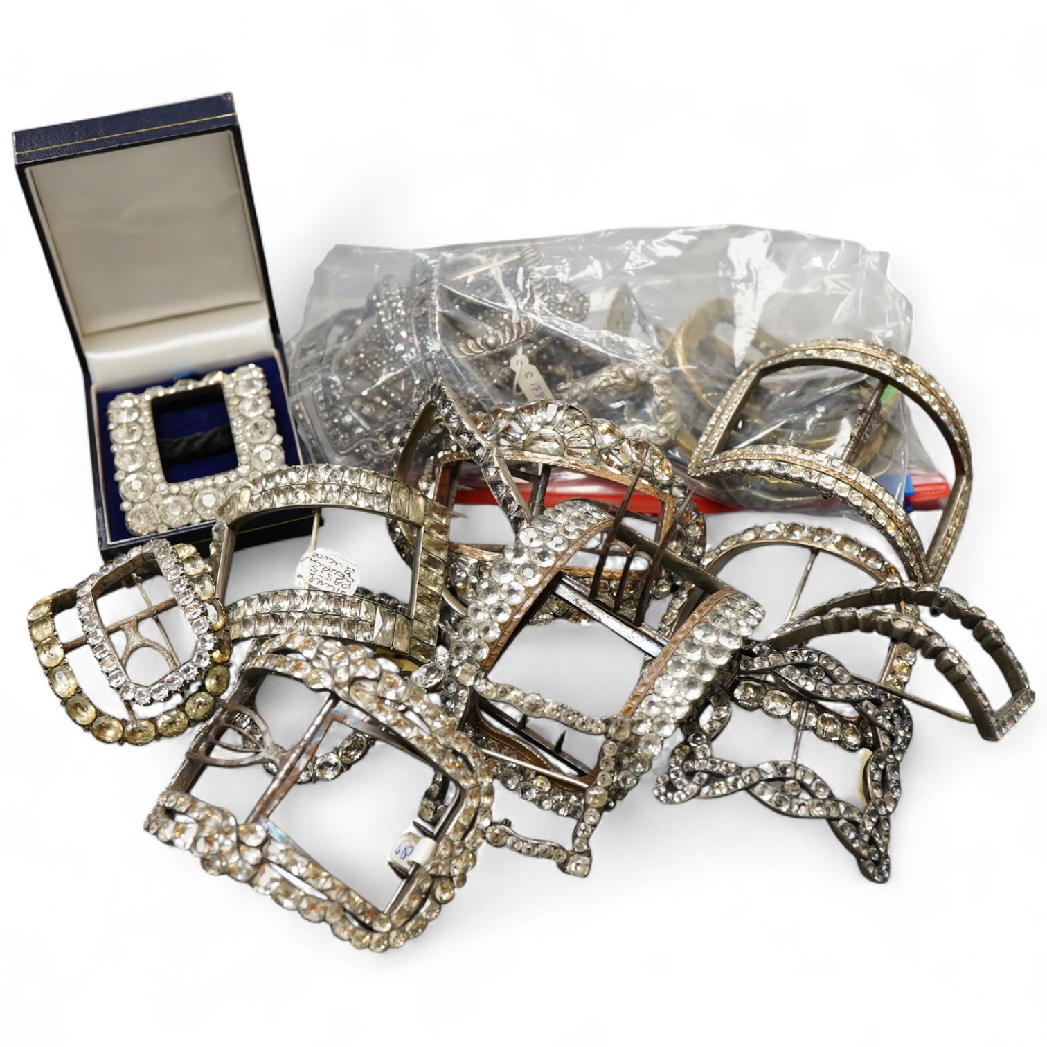 A large collection of buckles, 18th-19th century, of oval and rectangular outline, set with pastes or cut steel, mostly mounted in steel, a minority in silver, some with later brooch fittings